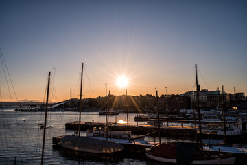 Fototapeta na wymiar Sunset over sailboats in the marina of Oslo, Norway