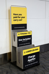 Metallic carry on luggage and personal item sizer at airport gate