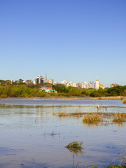 Uruguay river with high water levels and cityscape in the background - Uruguaiana, Brazil