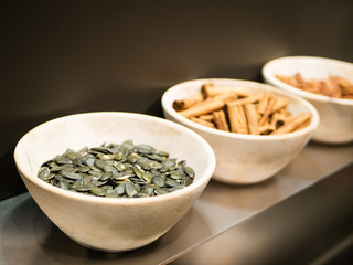 Bowl of pumpkin seed standing on a modern kitchen shelf
