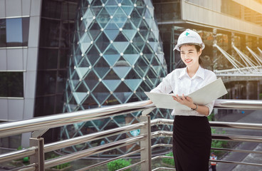 Inspection engineer woman working at construction site outdoors,Happy and smiling