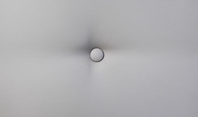 Creamy leather sofa background with buttons as a texture.