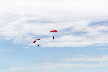 two men parachuting high in the sky.
