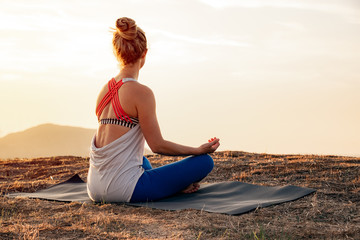 Young Meditating Woman Being Mindful Outdoors at Sunset