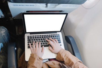 close-up hand typing keyboard computer in airplane