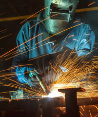 Worker welding the steel part by manua