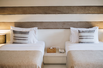 Fototapeta na wymiar big comfortable bed in brown classic bedroom