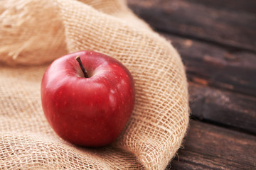 Red apples on dark wooden background. Space for text.