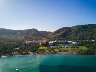 Fototapeta na wymiar Aerial drone photo of resort hotels on the Pacific Ocean coastline of Costa Rica