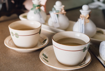  cup of tea on the wooden table with spa scrub jar treatment