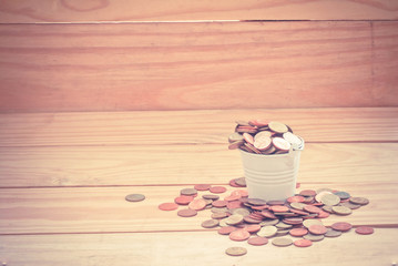 Coin in bucket concept saving money