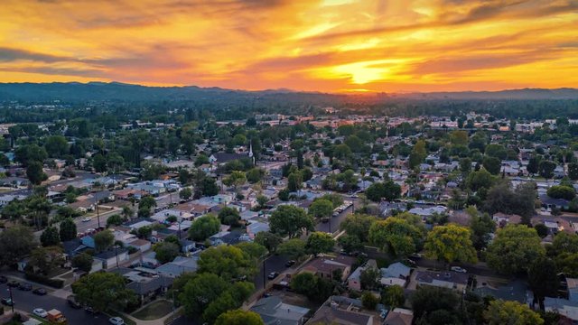 Aerial hyperlapse of scenic sunset over San Fernando Valley cityscape. Los Angeles, California.