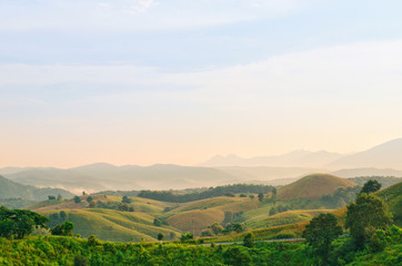 The landscape of mountain with forest in the morning with sunlight shining on mountain at rural area in the north of Thailand.