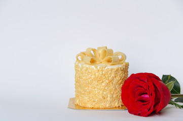 The butter cake and fresh red color rose that give for birthday present isolated on white background that have space for text.