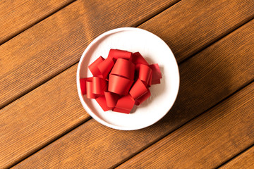 A small gift on a wooden table. The view from the top . The concept of a gift made with your own hands