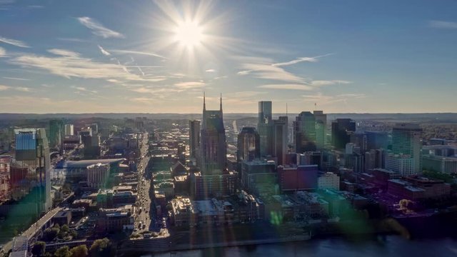 Tennessee Nashville Aerial v2 Cityscape hyperlapse passing over river and downtown into sun 10/18