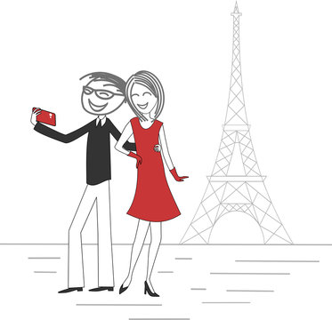 A couple of lovers take a picture of themselves with a mobile phone in Paris in front of the Eiffel Tower