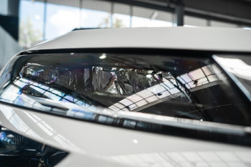 Obraz premium The headlamp of a modern prestigious car from a close angle