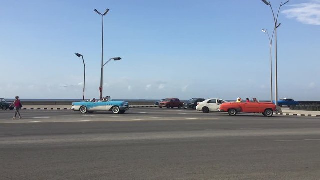 Vintage colourful cars driving on Malec&radic;&ge;n during a sunny day of July.