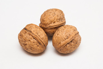 Three walnuts isolated on white background