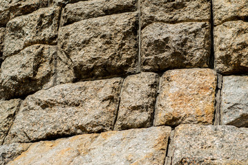 Fragment of a stone wall located close up