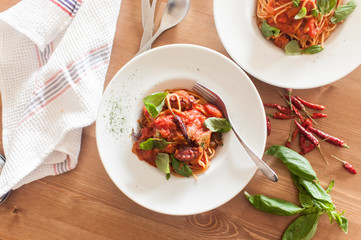 top view of weekend tomato and basil pasta lunch with wooden table
