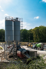 Concrete mixer and tractor on the construction site