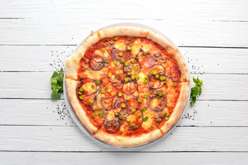 Pizza with tuna and onion. Italian traditional dish. On the old background. Top view. Free space for your text.