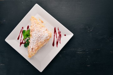 Cake Napoleon. On a wooden background. Top view. Free copy space.
