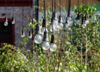Hanging light bulbs in terrace of abandoned caffe.
