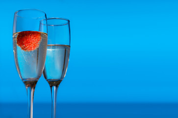 Pair of wine glass with one of them with strawberry