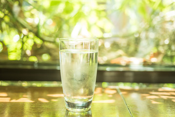 Cold glass of water on wooden table