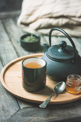 tea cup with tea pot on a tray