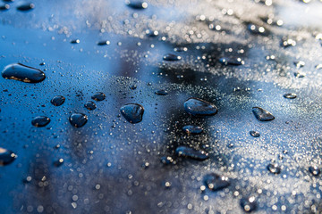 water droplets on a glossy black surface