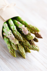 Fresh uncooked asparagus on a kitchen table. Close up view. The concept of healthy food.