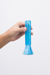 Hand with blue cleaning brush