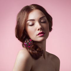 Portrait of young beautiful girl. Fashion photo. Girl with a vintage brooch in her hair. Beautiful Model Woman with Wavy Hairstyle