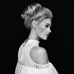 Blonde Girl with Elegant and shiny Hairstyle. Beautiful Model Woman with Curly Hairstyle. Care and Beauty Hair products. Perfect Make-Up