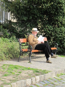 senior couple sitting on a bench in park