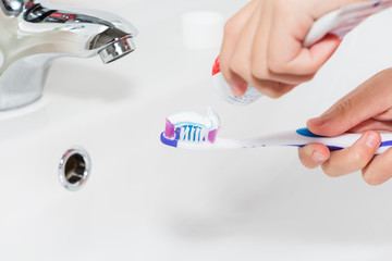 Toothpaste on a toothbrush, close-up. teeth care.