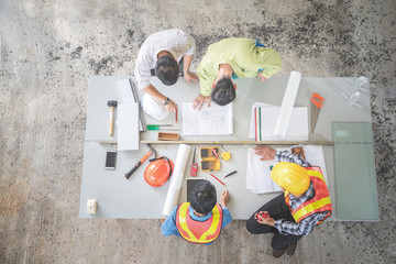 engineer people working and discussing with architecture or blueprint at construction site