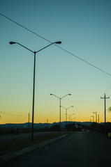 Road from the inside of a car and three light lamps