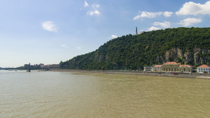 Gellert hill in Budapest, Hungary, view from river Denube in summer day with small clouds, selective focus