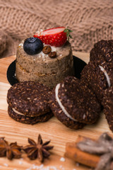 Chocolate cookies on a wooden table. Cookies close-up. Cinnamon, bergamot, coconut.