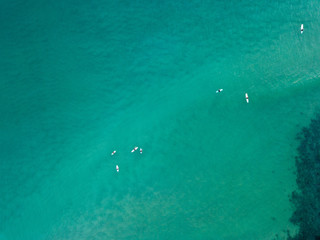 Some surfers sitting in the calm of the water