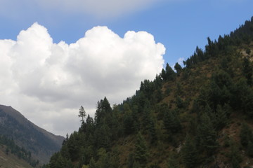 Mountains in kashmir under cloudy sky