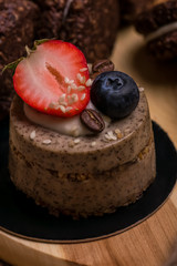 Chocolate dessert with strawberries and blueberries close-up. Cake and biscuits on the table. Cupcake.