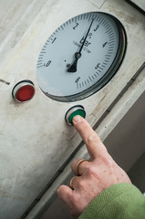 closeup of woman hand putting on green button to air tire presure maintenance for her car