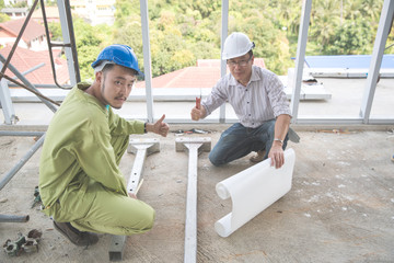 engineer people working and discussing with architecture or blueprint at construction site