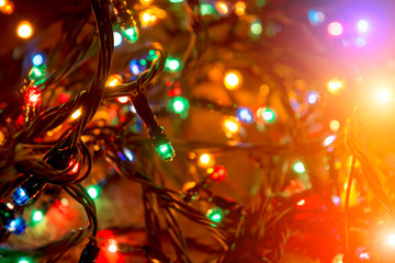 Fototapeta na wymiar Christmas blurred background. Color lights of an electric garland.